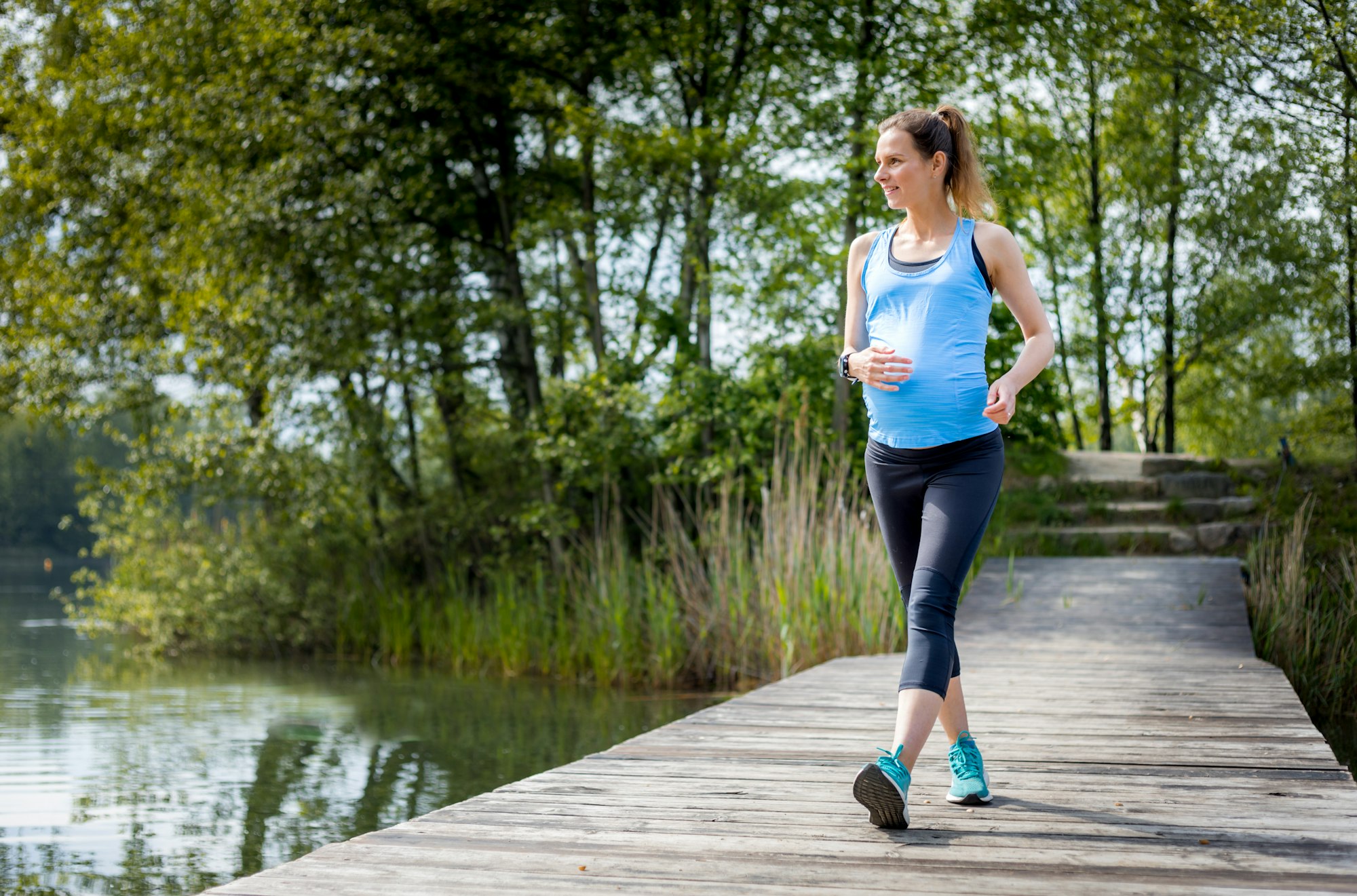 Active pregnant woman running outdoor, sport during pregnancy